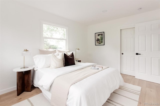 1617 S Quitman St, Denver, CO 80219 - bedroom featuring light wood-type flooring, baseboards, and a closet