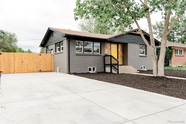 1617 S Quitman St, Denver, CO 80219 - view of front of home with brick siding and a gate