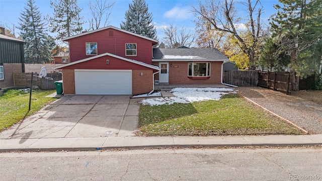 view of front of house featuring a front yard and a garage