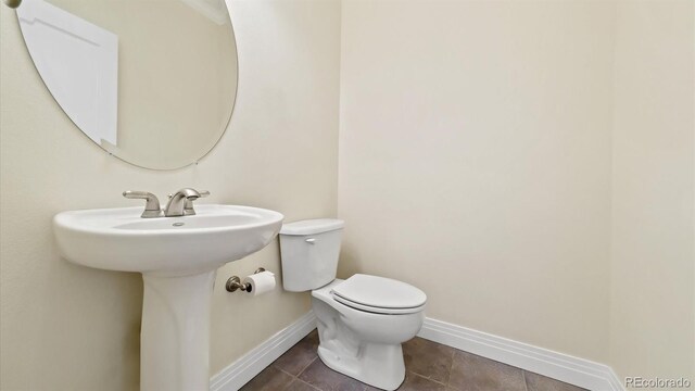 bathroom featuring tile patterned floors and toilet