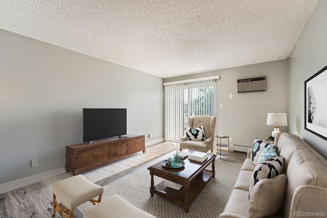 living area featuring a textured ceiling, a baseboard radiator, wood finished floors, baseboards, and an AC wall unit