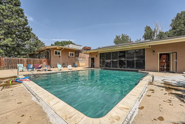 view of swimming pool with a fenced in pool, a patio, and fence