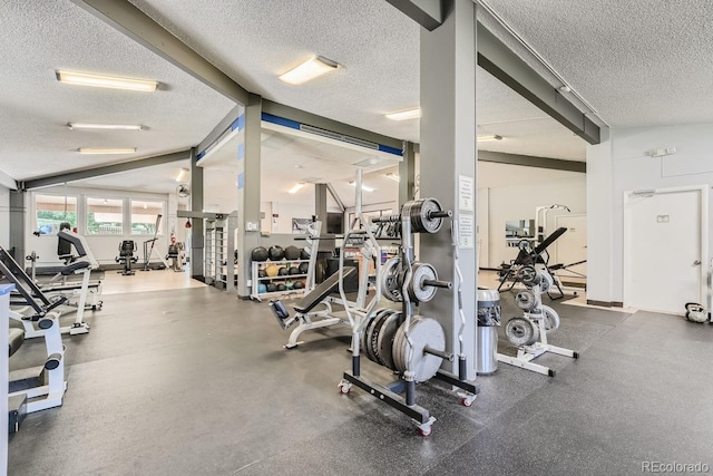 exercise room with a textured ceiling and vaulted ceiling