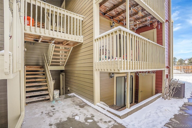 view of snow covered exterior featuring central AC unit