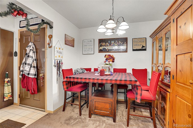 dining area with a chandelier and light tile patterned floors