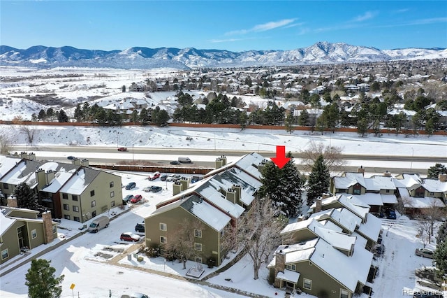 snowy aerial view featuring a mountain view