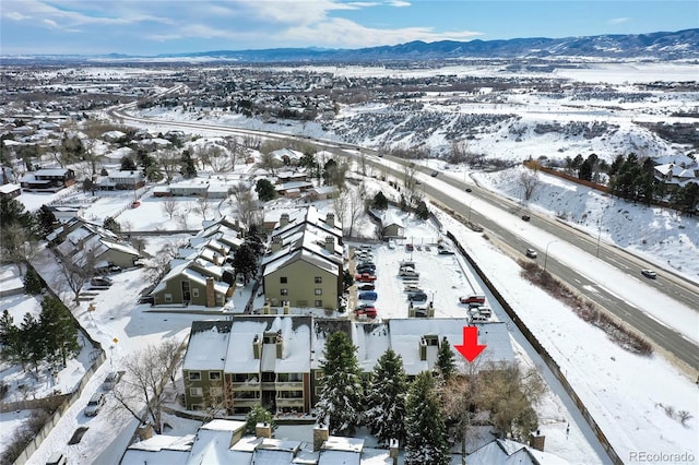 snowy aerial view with a mountain view