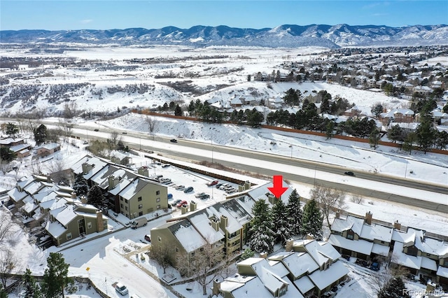 snowy aerial view featuring a mountain view