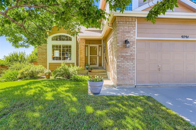 9791 Sterling Dr, Highlands Ranch, CO 80126 - view of front facade with a front lawn, brick siding, concrete driveway, and an attached garage