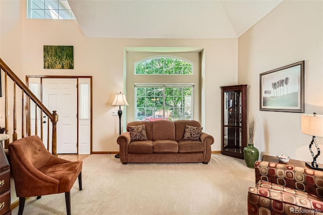 9791 Sterling Dr, Highlands Ranch, CO 80126 - living room with light colored carpet, stairs, and high vaulted ceiling
