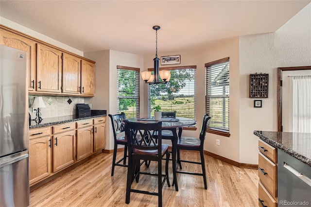 9791 Sterling Dr, Highlands Ranch, CO 80126 - dining space featuring light wood-type flooring, plenty of natural light, and a chandelier