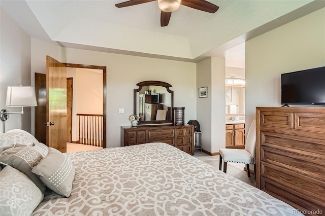 9791 Sterling Dr, Highlands Ranch, CO 80126 - bedroom with a tray ceiling, light carpet, connected bathroom, and a ceiling fan