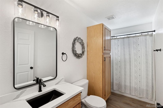 7654 Crestone Peak Trl, Colorado Springs, CO 80924 - full bath featuring toilet, vanity, a closet, and wood finished floors