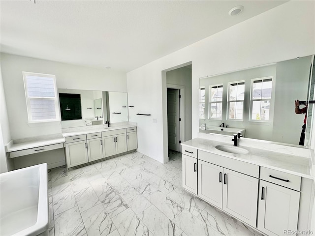 16521 Black Rose Cir, Parker, CO 80134 - bathroom with two vanities, a freestanding tub, marble finish floors, and plenty of natural light