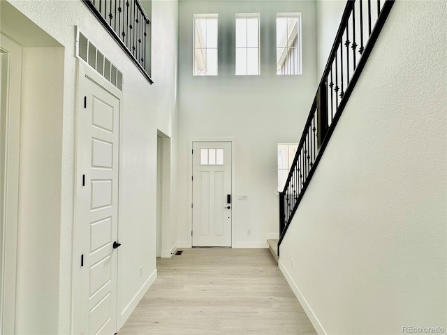 16521 Black Rose Cir, Parker, CO 80134 - entrance foyer featuring stairs, light wood-style flooring, and a high ceiling
