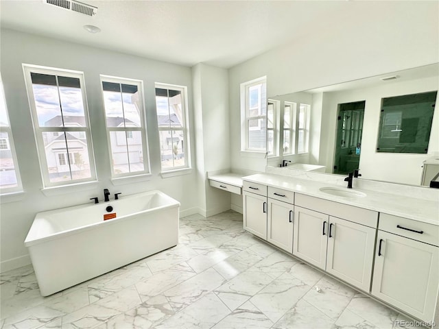 16521 Black Rose Cir, Parker, CO 80134 - full bathroom featuring marble look tiles, vanity, and a freestanding tub