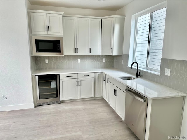 16521 Black Rose Cir, Parker, CO 80134 - kitchen with beverage cooler, dishwasher, built in microwave, tasteful backsplash, and light wood finished floors