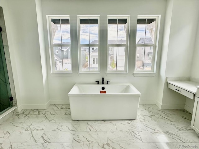 16521 Black Rose Cir, Parker, CO 80134 - full bathroom with marble look tile flooring, a freestanding tub, vanity, and a stall shower