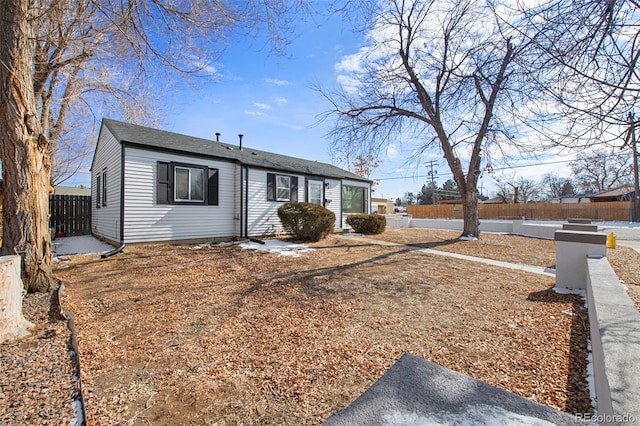 single story home featuring fence