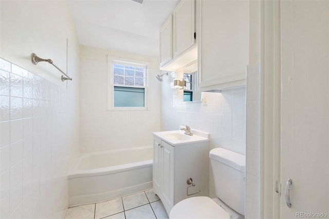 full bath featuring bathing tub / shower combination, tile walls, toilet, vanity, and tile patterned flooring