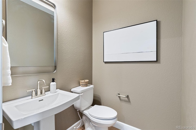 bathroom featuring sink and toilet