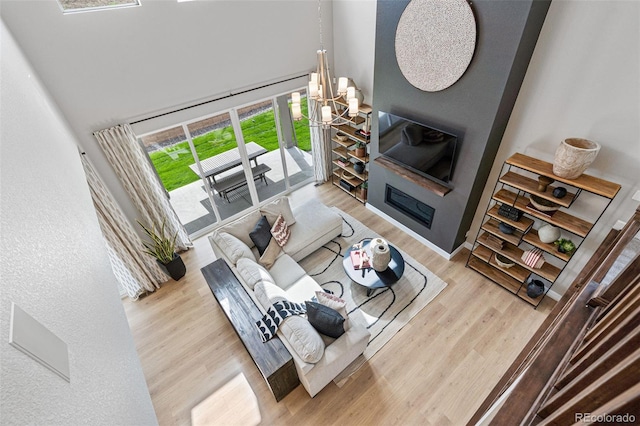 living room featuring an inviting chandelier and light hardwood / wood-style floors