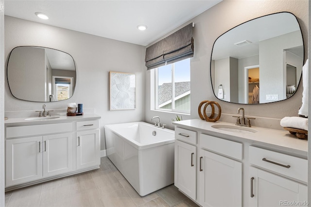 bathroom with vanity and a washtub