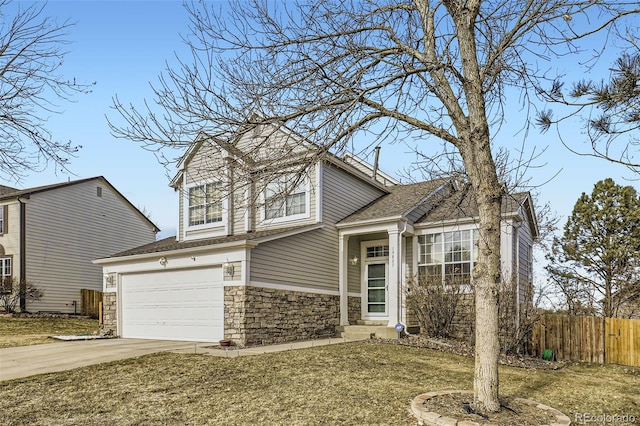 tri-level home featuring driveway, stone siding, fence, a shingled roof, and a garage