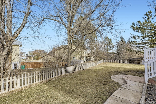 view of yard featuring a residential view and a fenced backyard