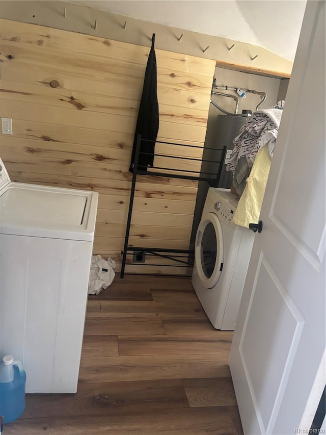206 Lyell St, Monte Vista, CO 81144 - laundry room featuring washer / dryer, water heater, wood finished floors, and wood walls