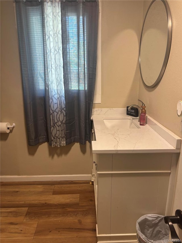 206 Lyell St, Monte Vista, CO 81144 - half bathroom featuring vanity and wood finished floors