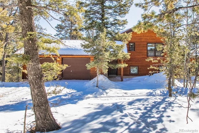 log-style house with a garage