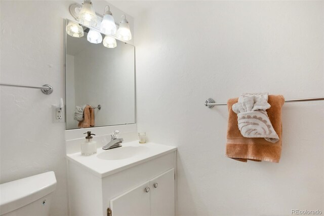 bathroom featuring vanity and toilet