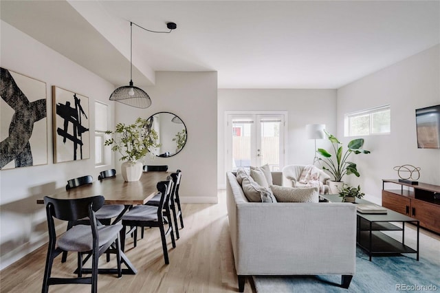 living room featuring french doors and light wood-type flooring