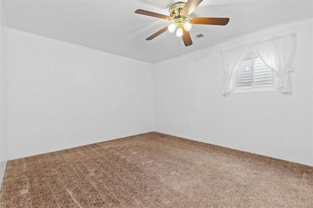 carpeted empty room with visible vents and ceiling fan