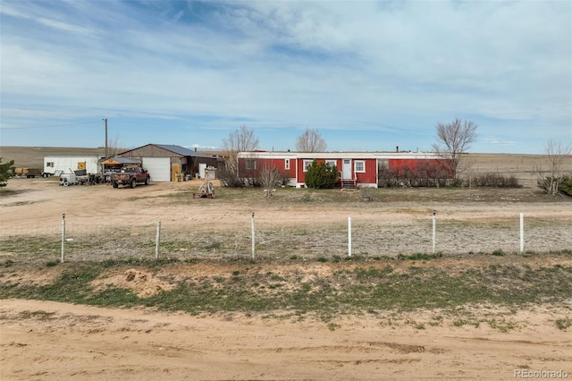 41215 Alta Vista Rd, Ramah, CO 80832 - view of front of house with an outbuilding, driveway, a garage, and fence
