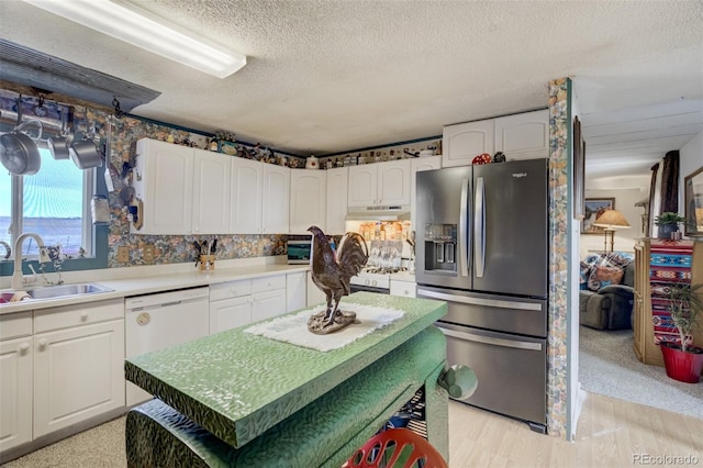 41215 Alta Vista Rd, Ramah, CO 80832 - kitchen with under cabinet range hood, a sink, white appliances, and white cabinets