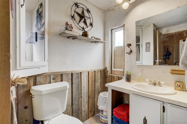 41215 Alta Vista Rd, Ramah, CO 80832 - bathroom with toilet, wood walls, vanity, and a wainscoted wall