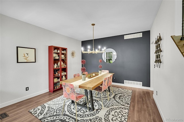 215 Mcafee Cir, Erie, CO 80516 - dining area with wood finished floors and a chandelier