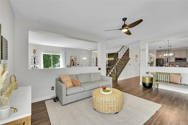 215 Mcafee Cir, Erie, CO 80516 - living room with stairs, wood finished floors, ceiling fan, and a chandelier
