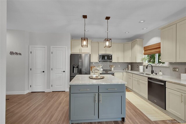 215 Mcafee Cir, Erie, CO 80516 - kitchen with appliances with stainless steel finishes, decorative backsplash, light wood finished floors, and recessed lighting
