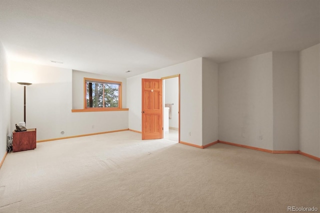 carpeted empty room with baseboards