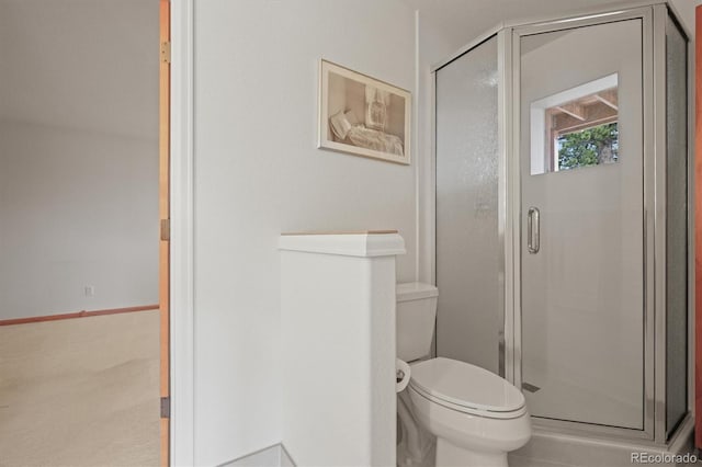 bathroom featuring toilet and a shower stall