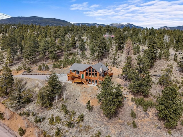 birds eye view of property with a view of trees and a mountain view