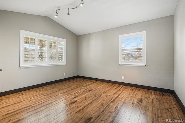 19423 W 52nd Dr, Golden, CO 80403 - unfurnished room with wood-type flooring, baseboards, and vaulted ceiling