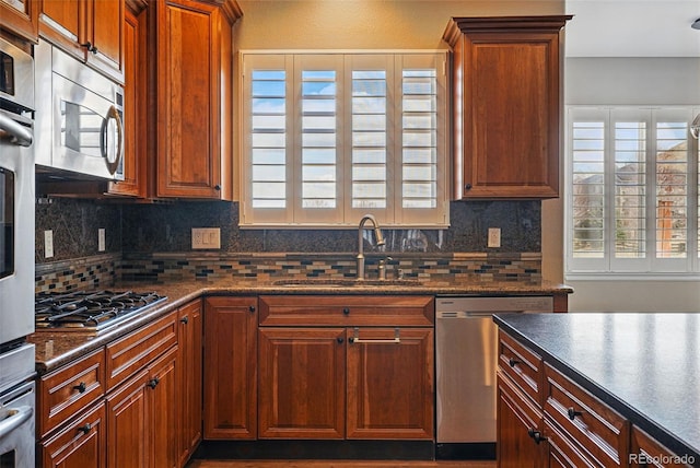 19423 W 52nd Dr, Golden, CO 80403 - kitchen with a sink, dark countertops, appliances with stainless steel finishes, and a wealth of natural light