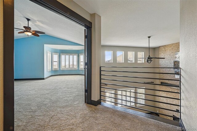 19423 W 52nd Dr, Golden, CO 80403 - hall featuring baseboards, vaulted ceiling, carpet, and a textured ceiling