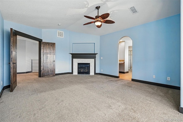 19423 W 52nd Dr, Golden, CO 80403 - unfurnished living room featuring carpet floors, visible vents, lofted ceiling, and ceiling fan