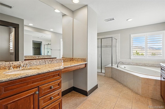 19423 W 52nd Dr, Golden, CO 80403 - bathroom with a garden tub, visible vents, a stall shower, and tile patterned flooring