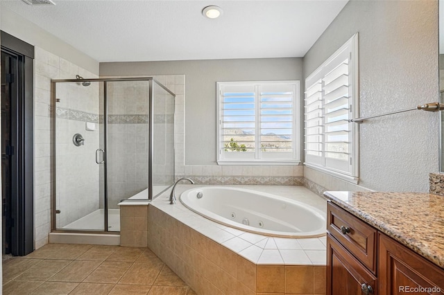 19423 W 52nd Dr, Golden, CO 80403 - full bath featuring a stall shower, vanity, tile patterned flooring, and a jetted tub